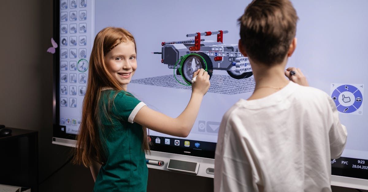 A boy and a girl are playing a video game on a computer screen.