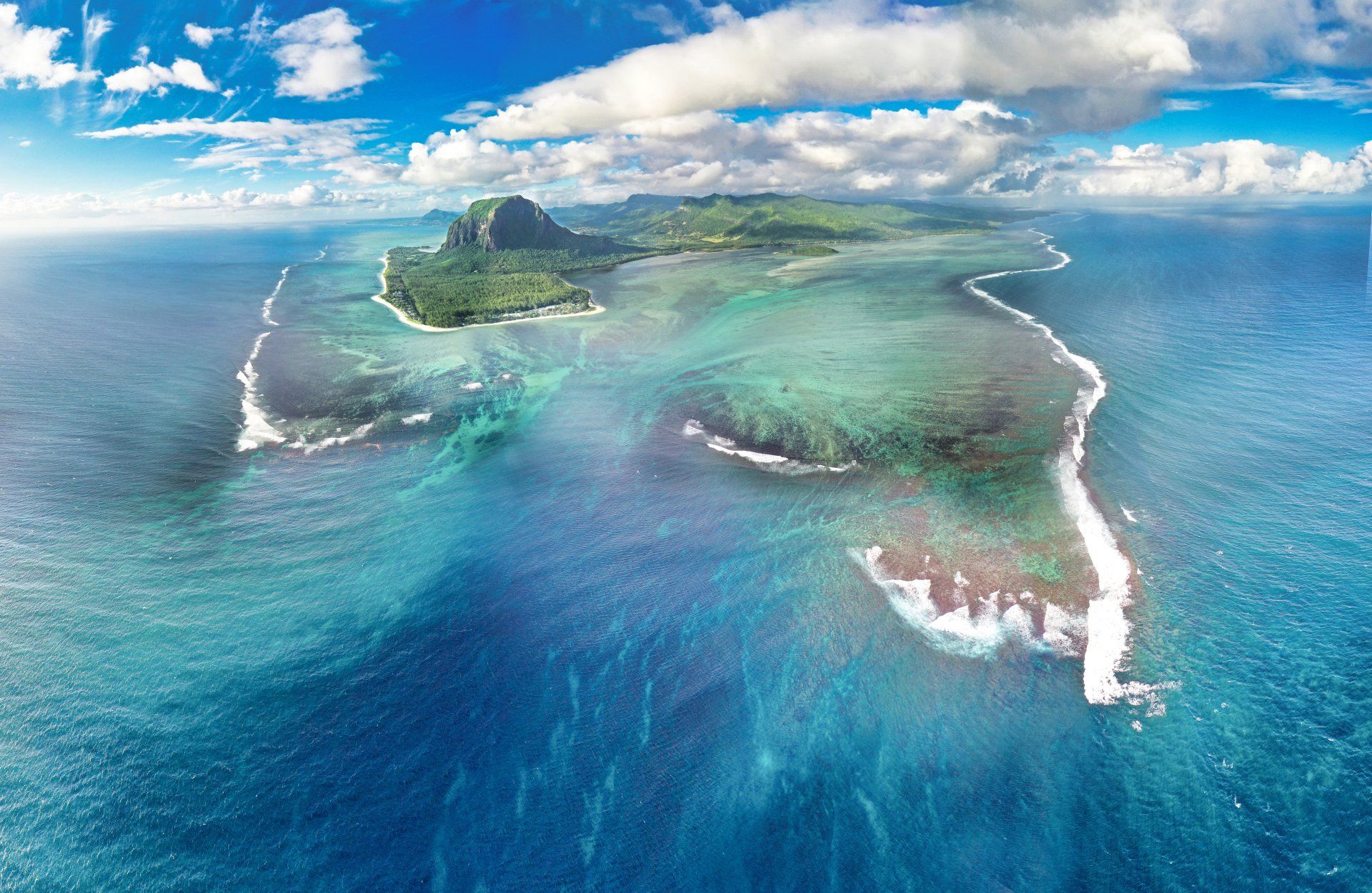 An aerial view of a small island in the middle of the ocean.