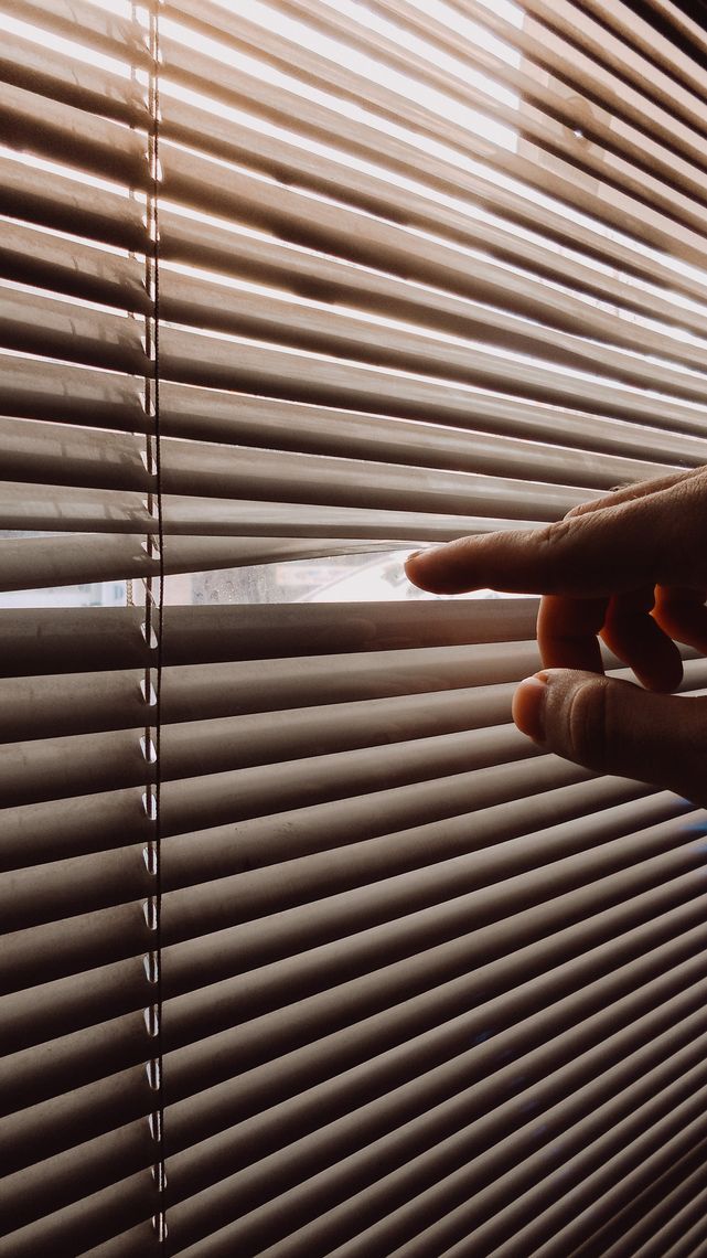 A bathroom with blinds installed in the windows and door