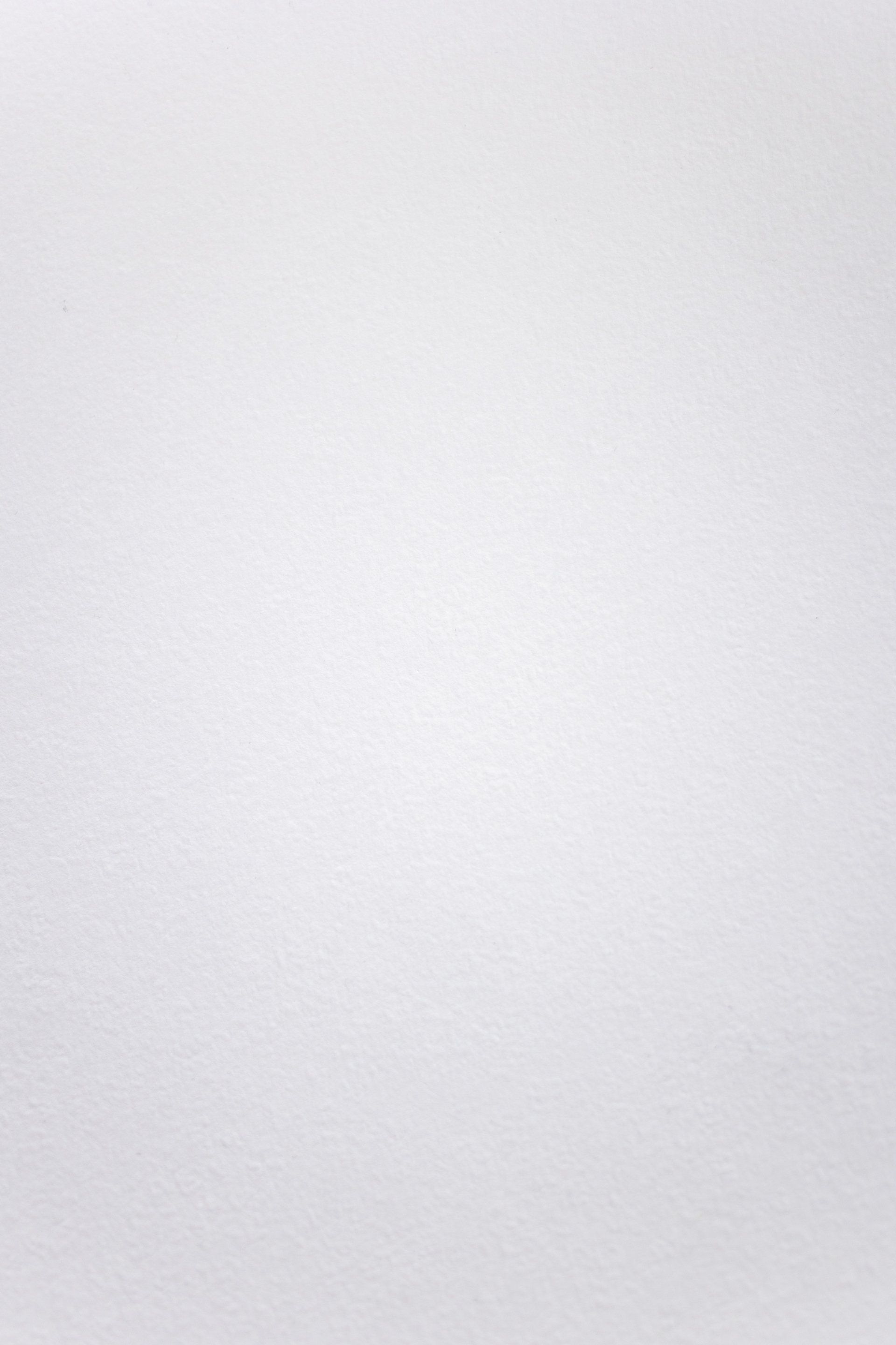 A close-up of a plain white textured surface.