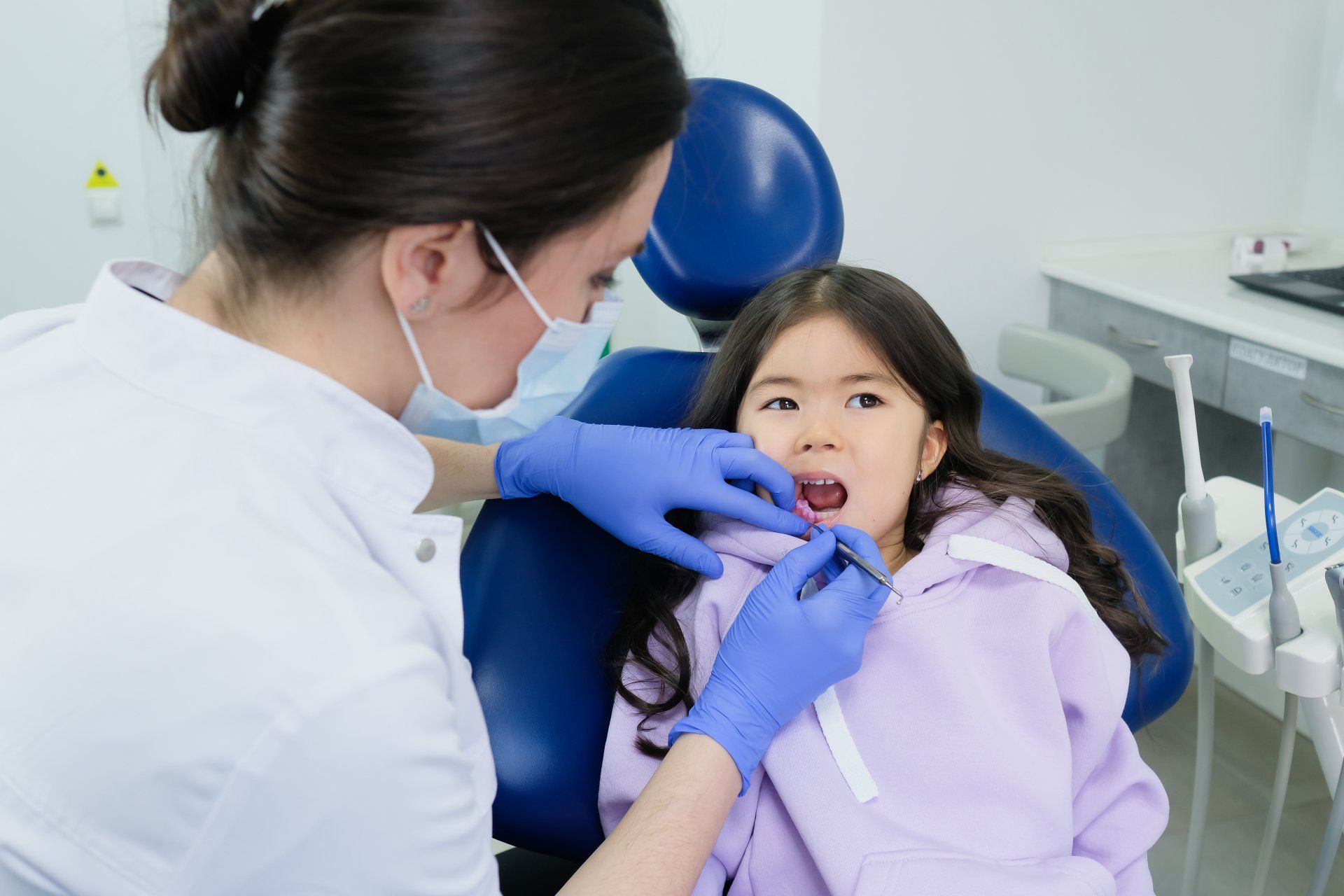 dentist working on little girls mouth