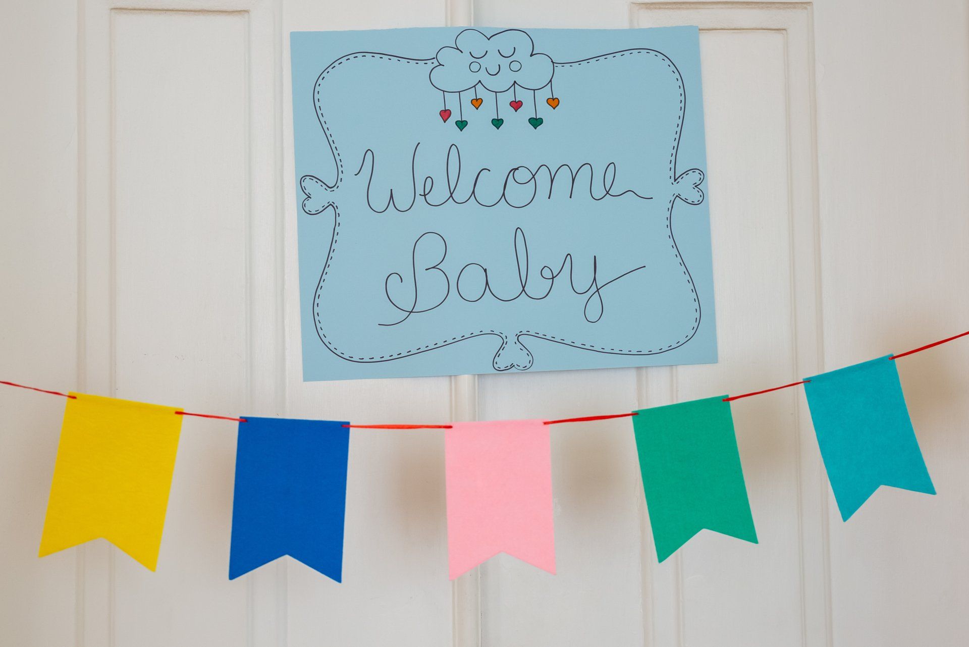 a welcome baby sign is hanging on a door