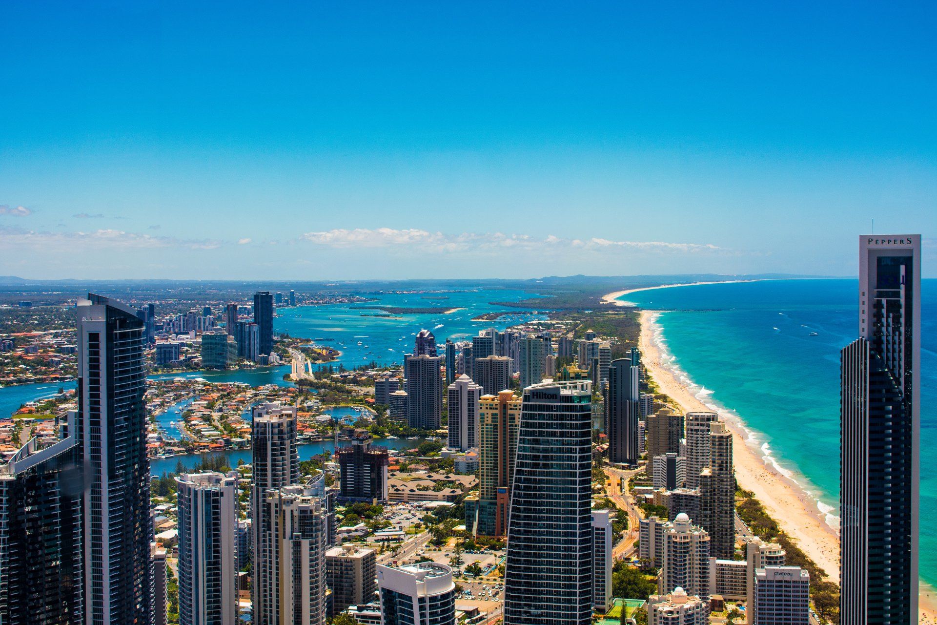 An aerial view of a city with tall buildings and a beach.