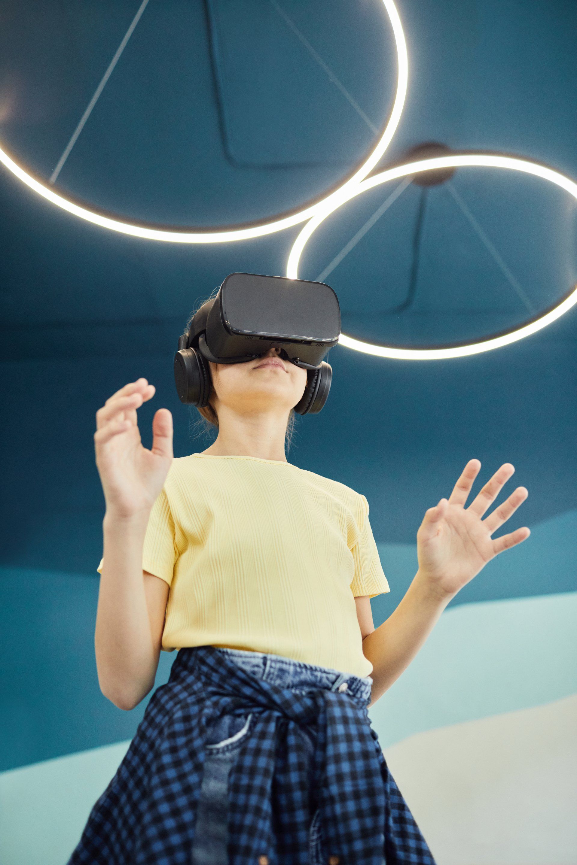a young girl wearing a virtual reality headset
