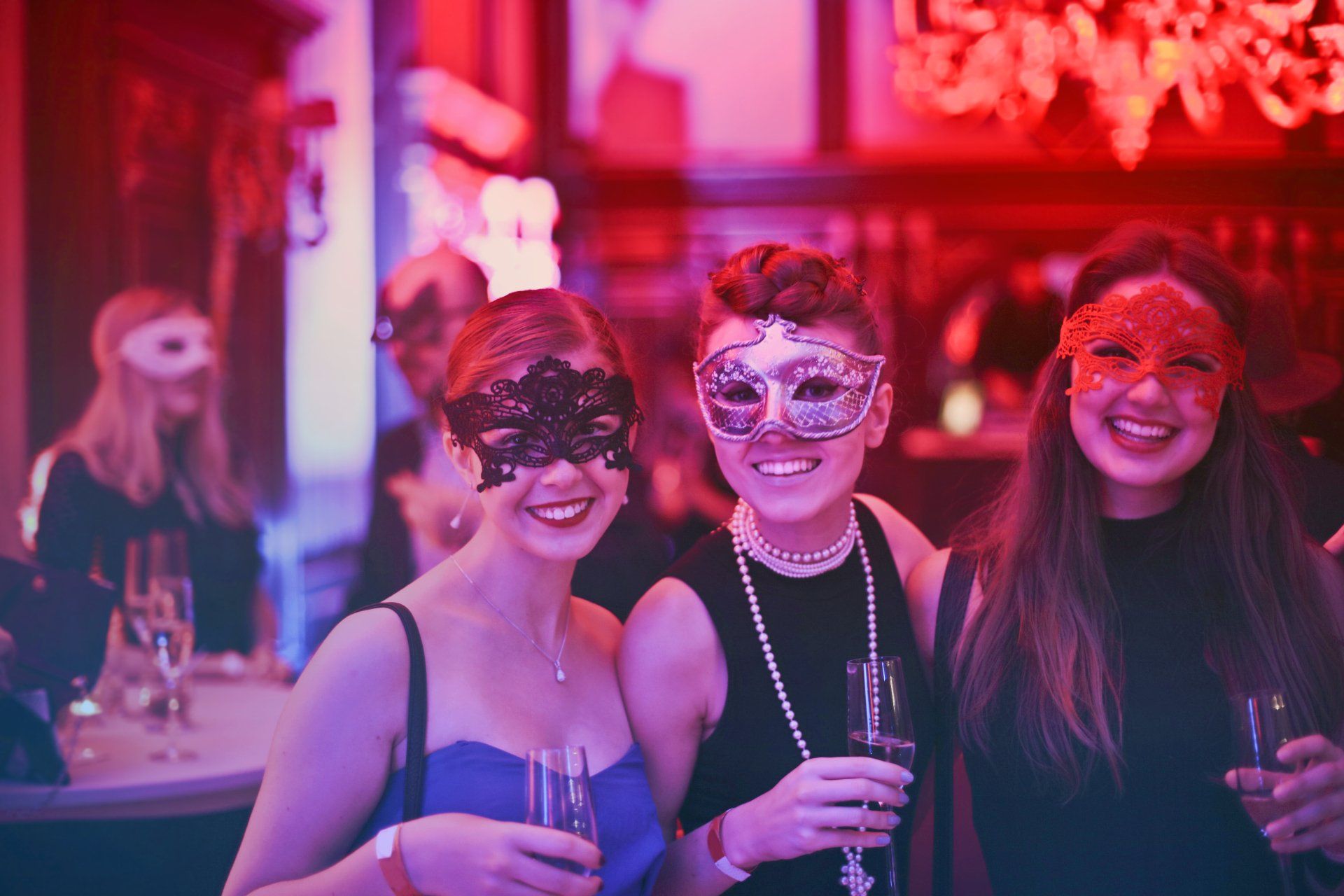 A group of friends enjoying a good time at a corporate event in Waco, TX with Flash Party Photo Booth's masquerade decorations.