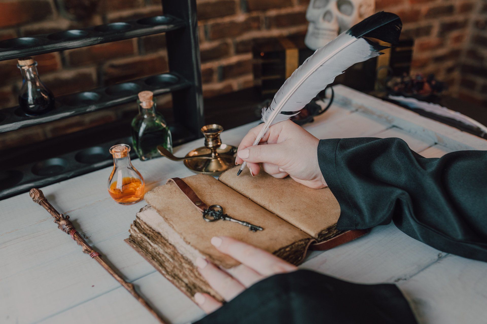 A person is writing in a book with a feather pen.