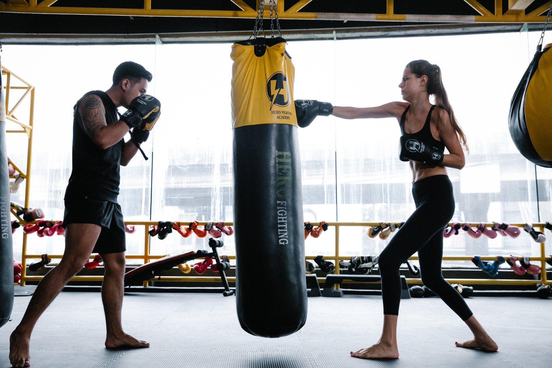 Athlete couple training with punching bag, free of shoulder pain