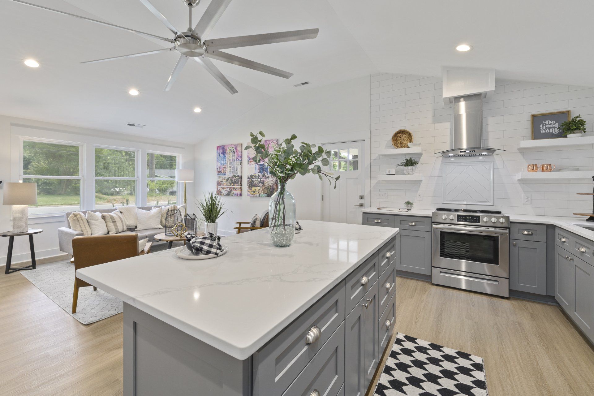 a kitchen with stainless steel appliances and grey cabinets