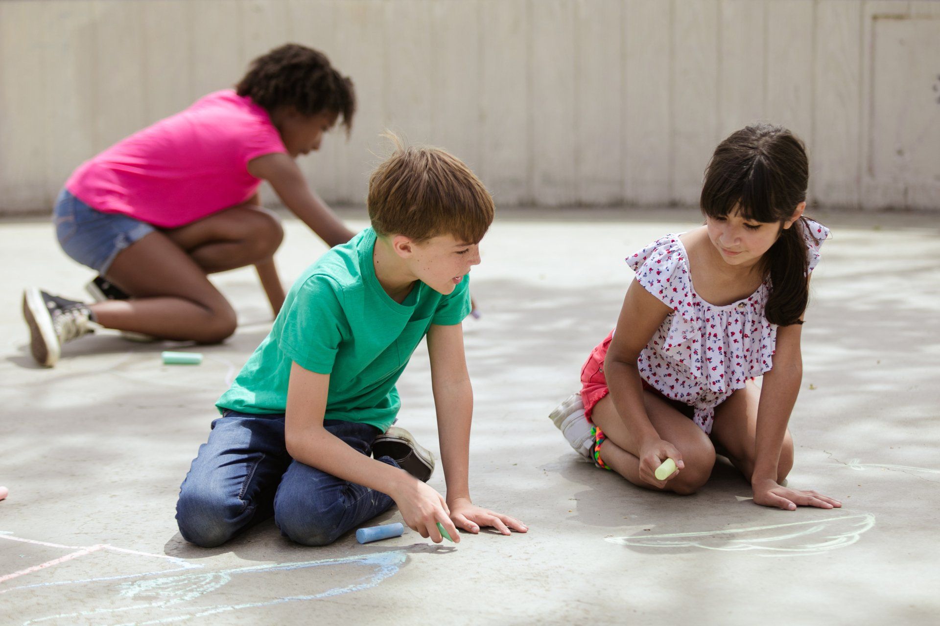 A group of kids drawing with chalk