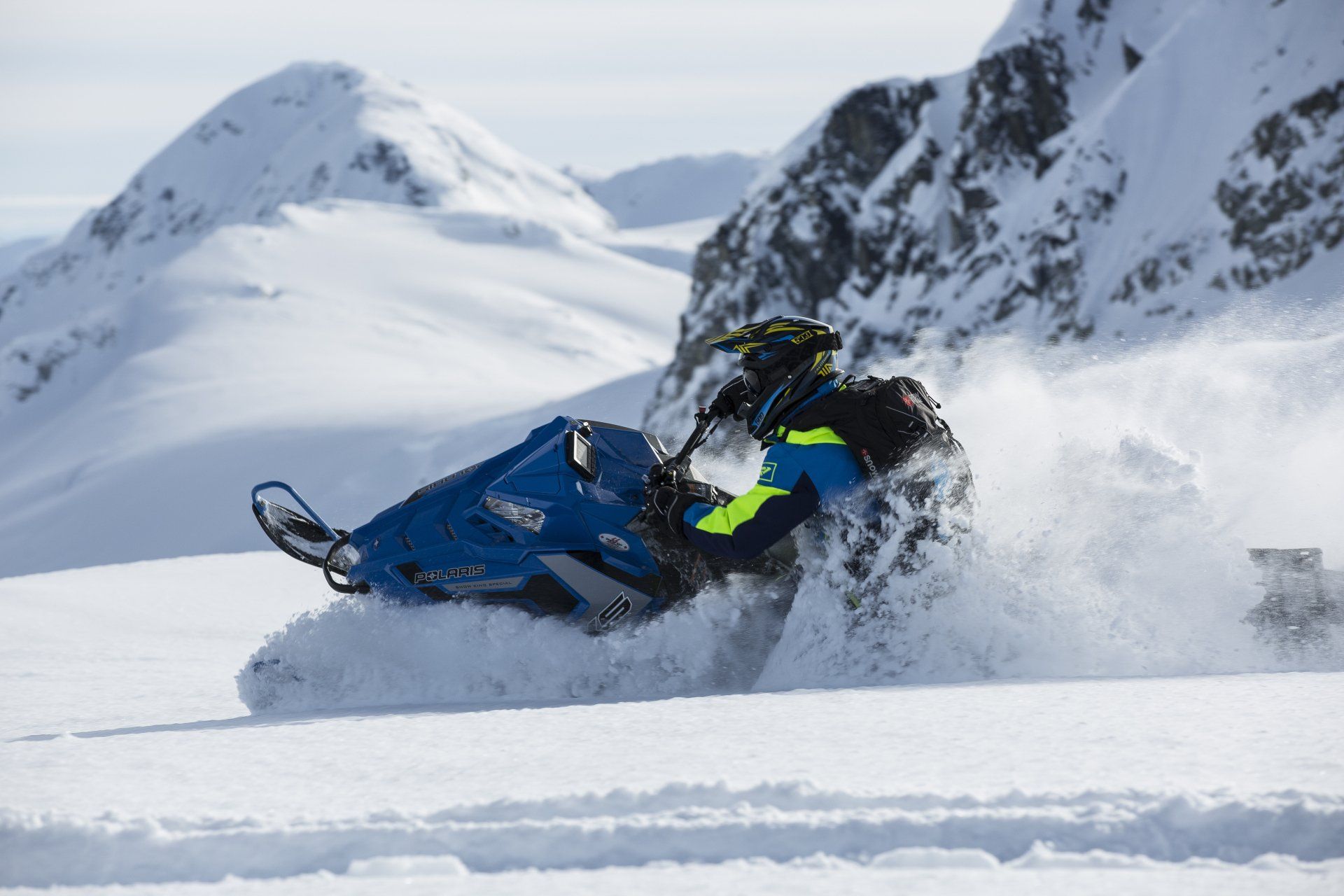 man riding snowmobile in heavy powder