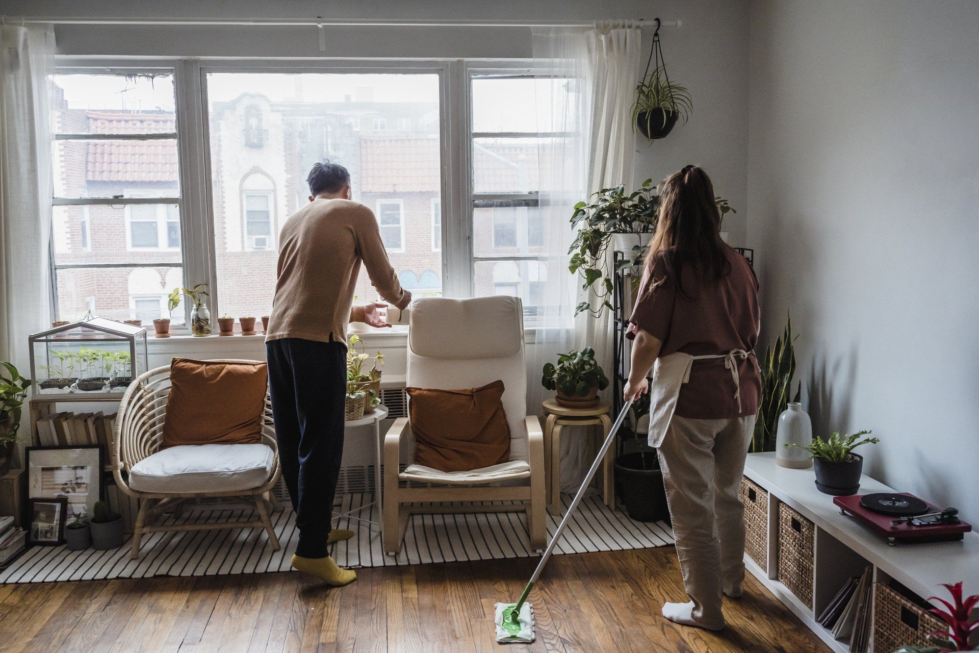 a couple cleaning their apartment