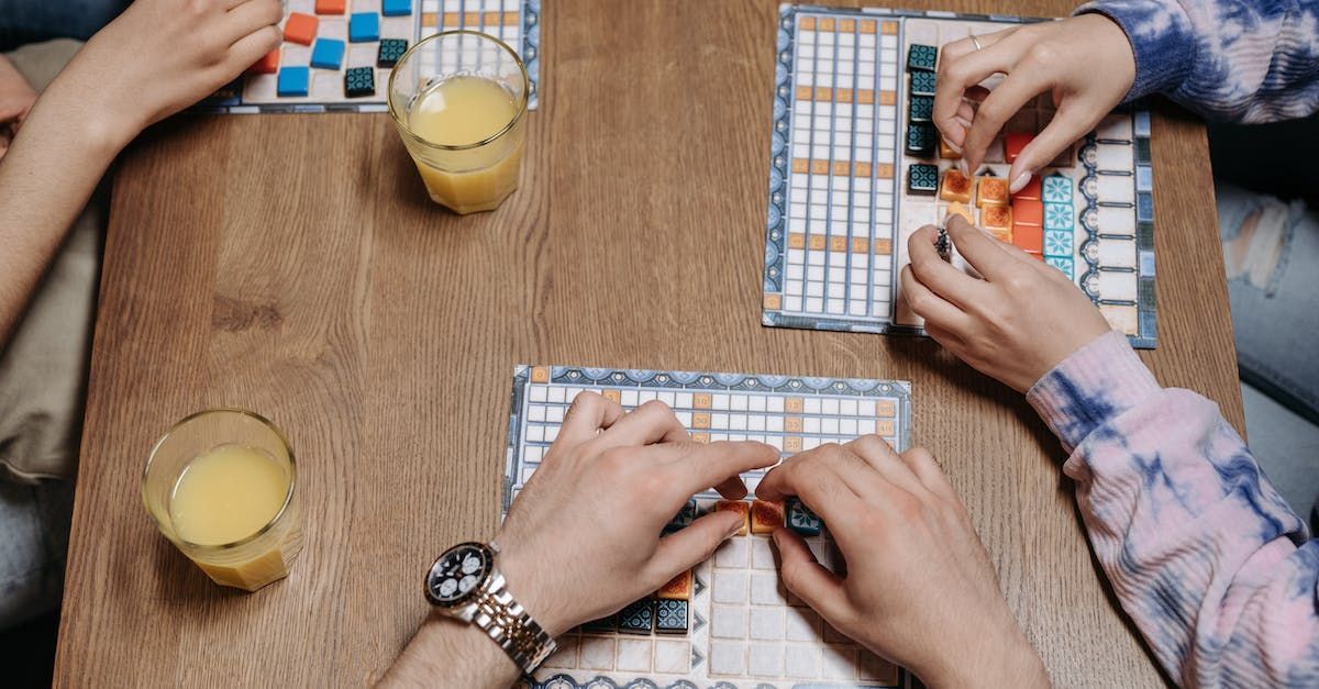 A group of people are sitting at a table playing a board game.