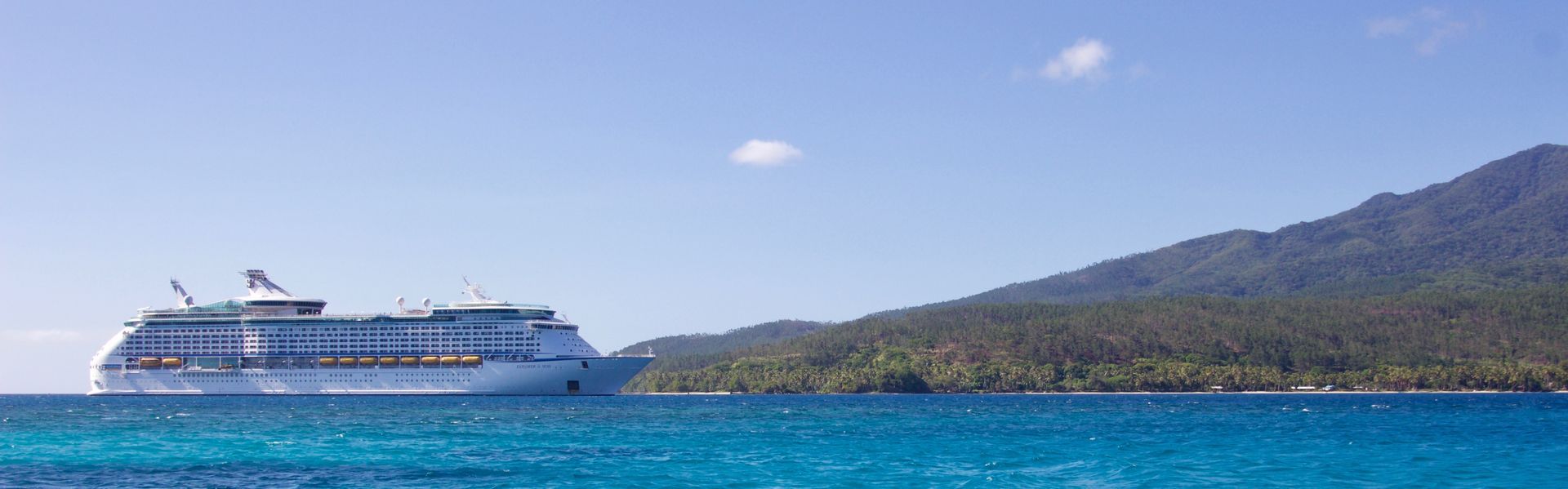 A cruise ship is floating on top of a body of water.