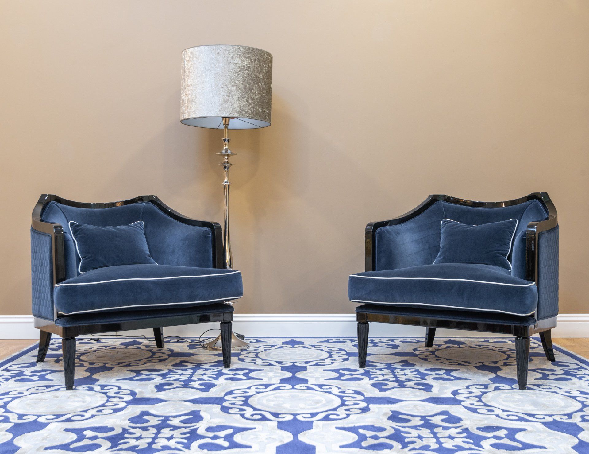 There are two chairs and a lamp in the room.