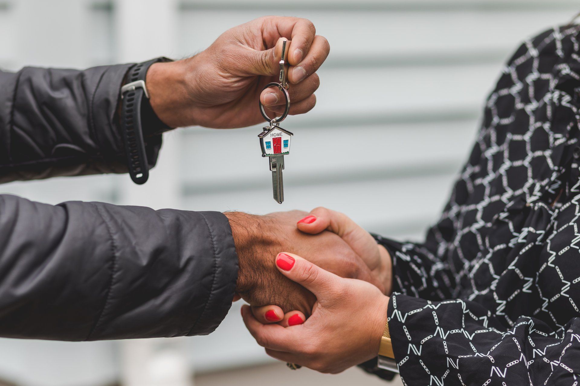Man handing woman the keys to a new property