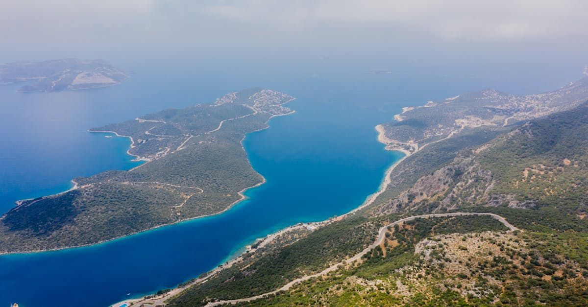 An aerial view of a large body of water surrounded by mountains.