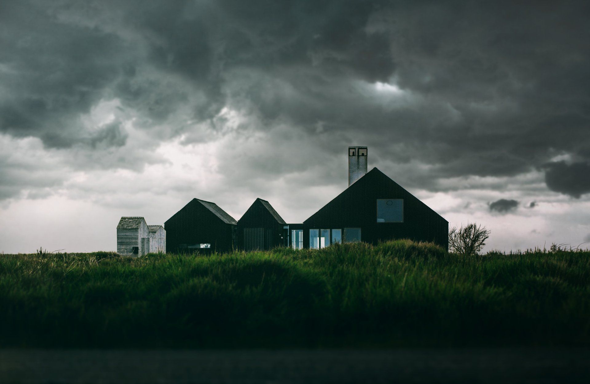 Ominous photo of a house surrounded by dark clouds