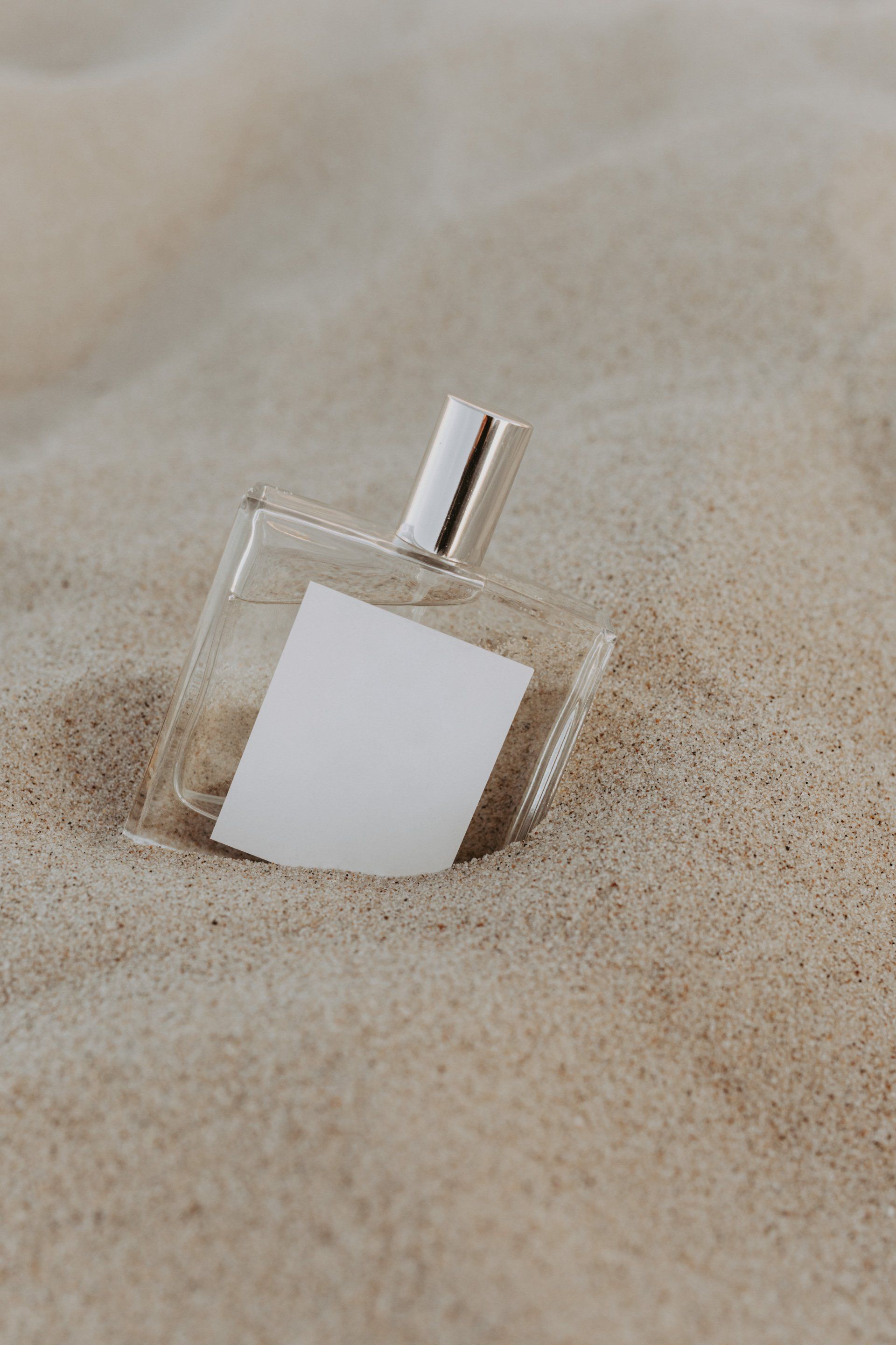 perfume bottle in the sand