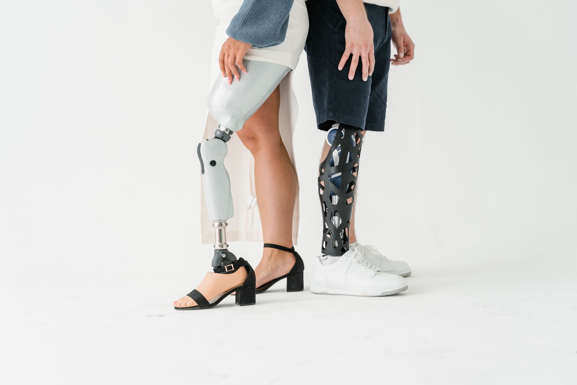 A man and a woman with prosthetic legs are standing next to each other.