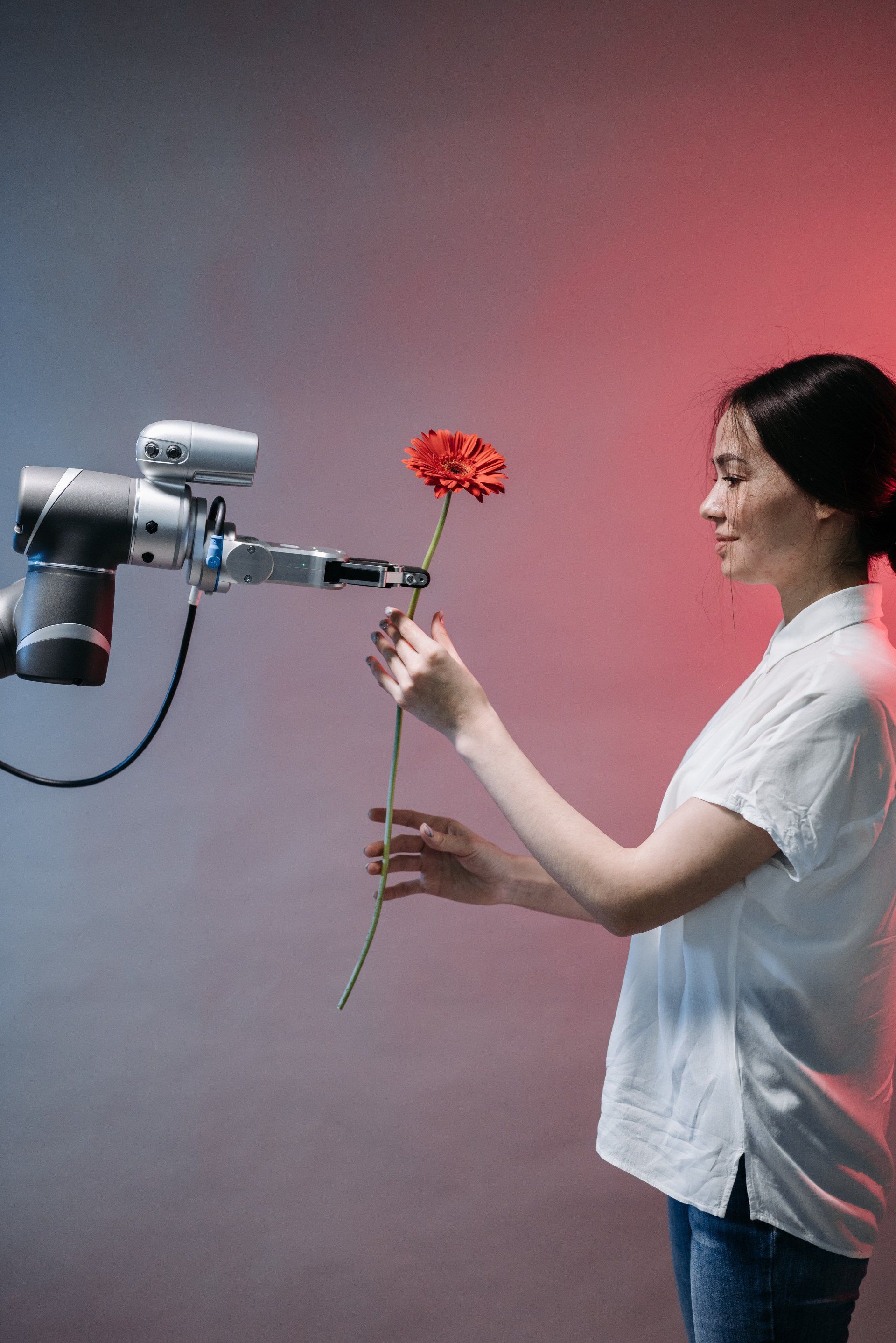 Image of a woman accepting a flower from an AI robot