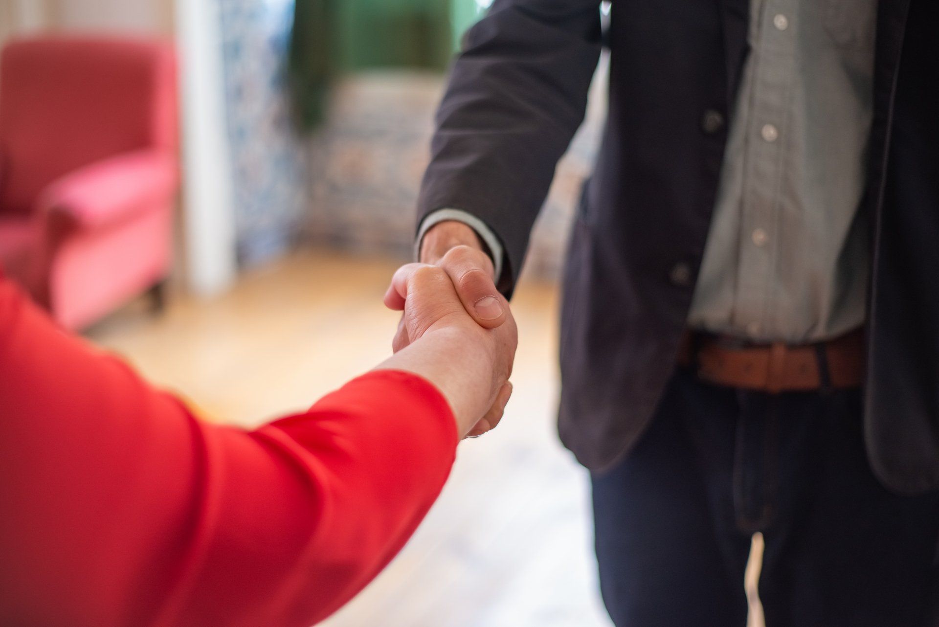 a man and a woman are shaking hands after a vehicle repair transaction