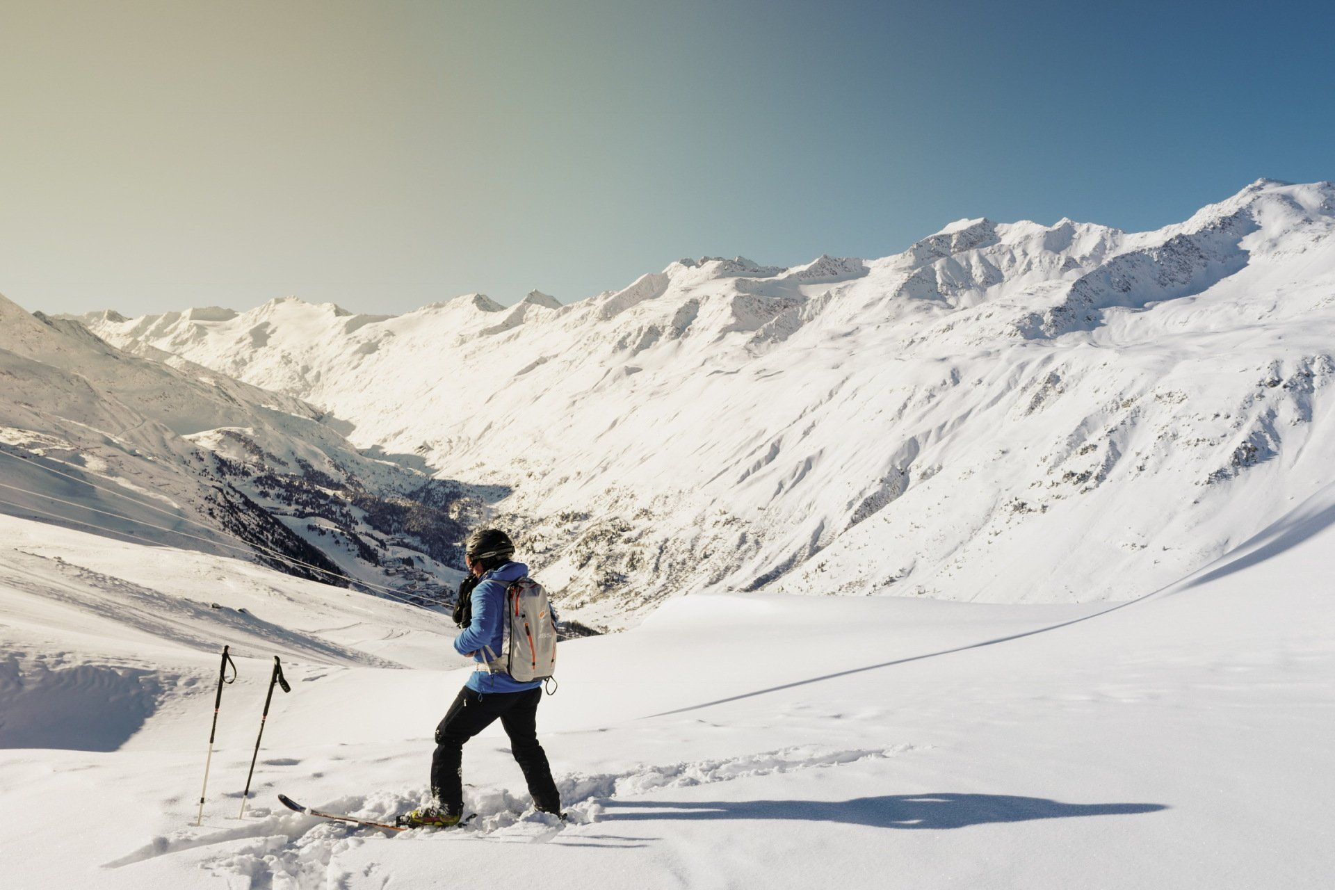 A person is skiing down a snow covered mountain.