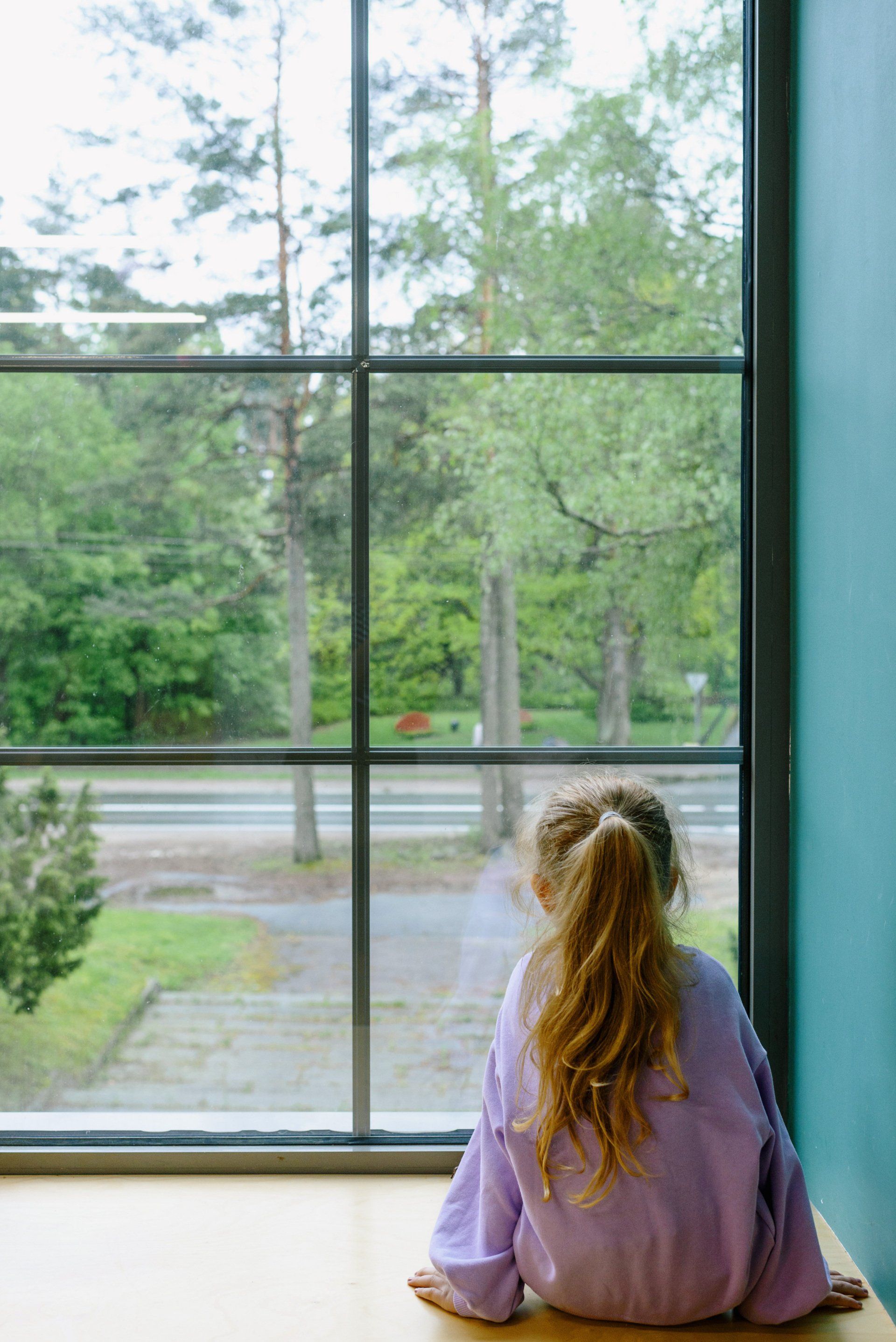 a child looking by the window