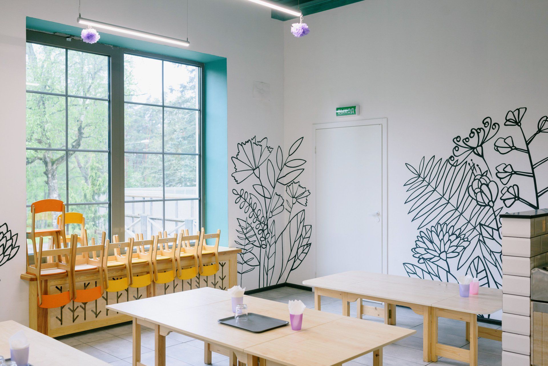 a school classroom with a green exit sign on the door