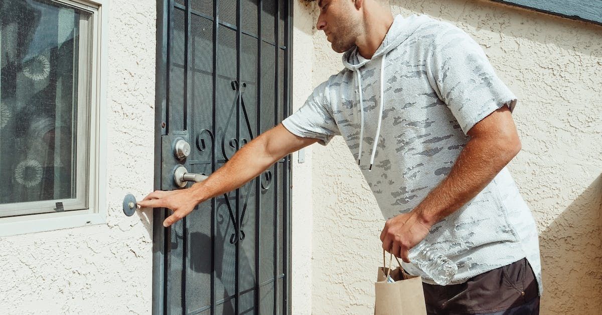 A man is pressing a doorbell