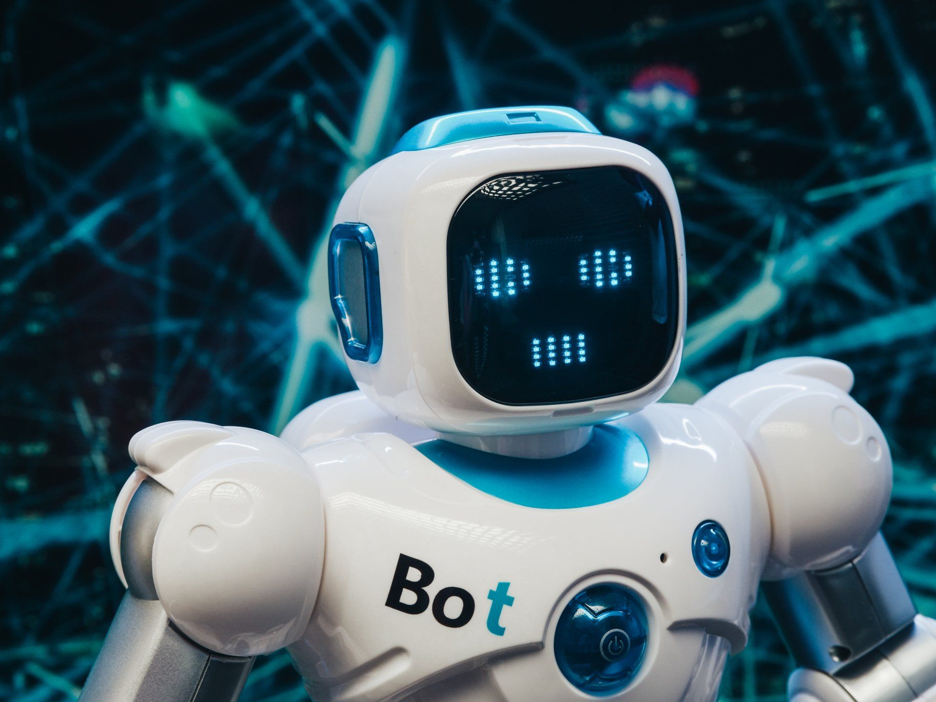 A white and blue robot with the word bot on it