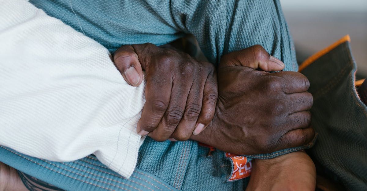 A close up of a person holding another person 's hand.