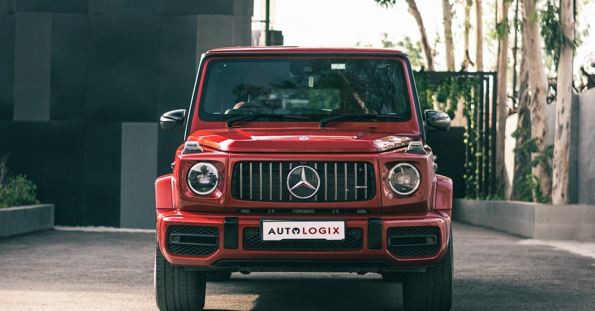 Red Mercedes-Benz G-Class SUV parked in front of a modern building | 5 Star Auto Repair