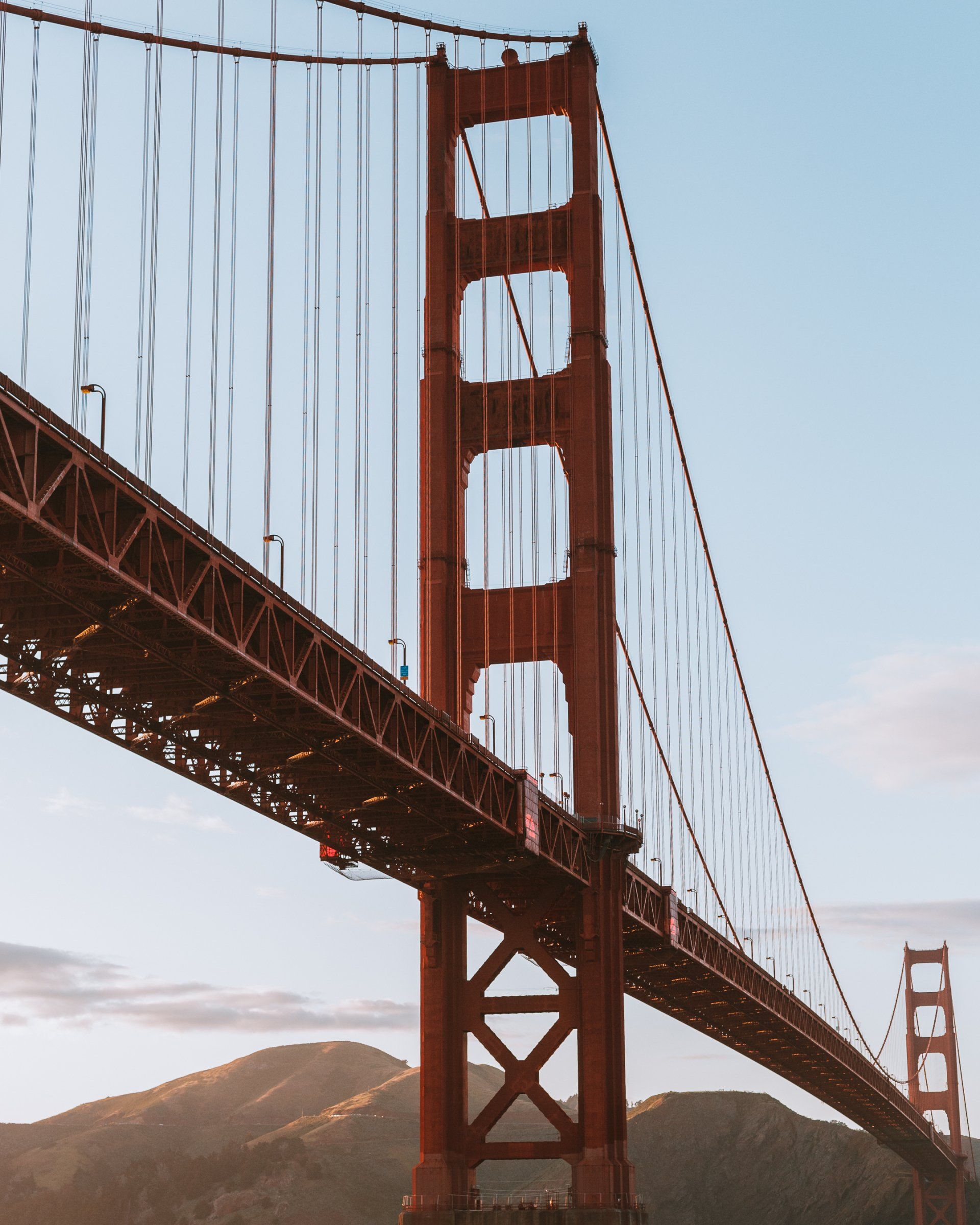 A red bridge with a blue sky in the background