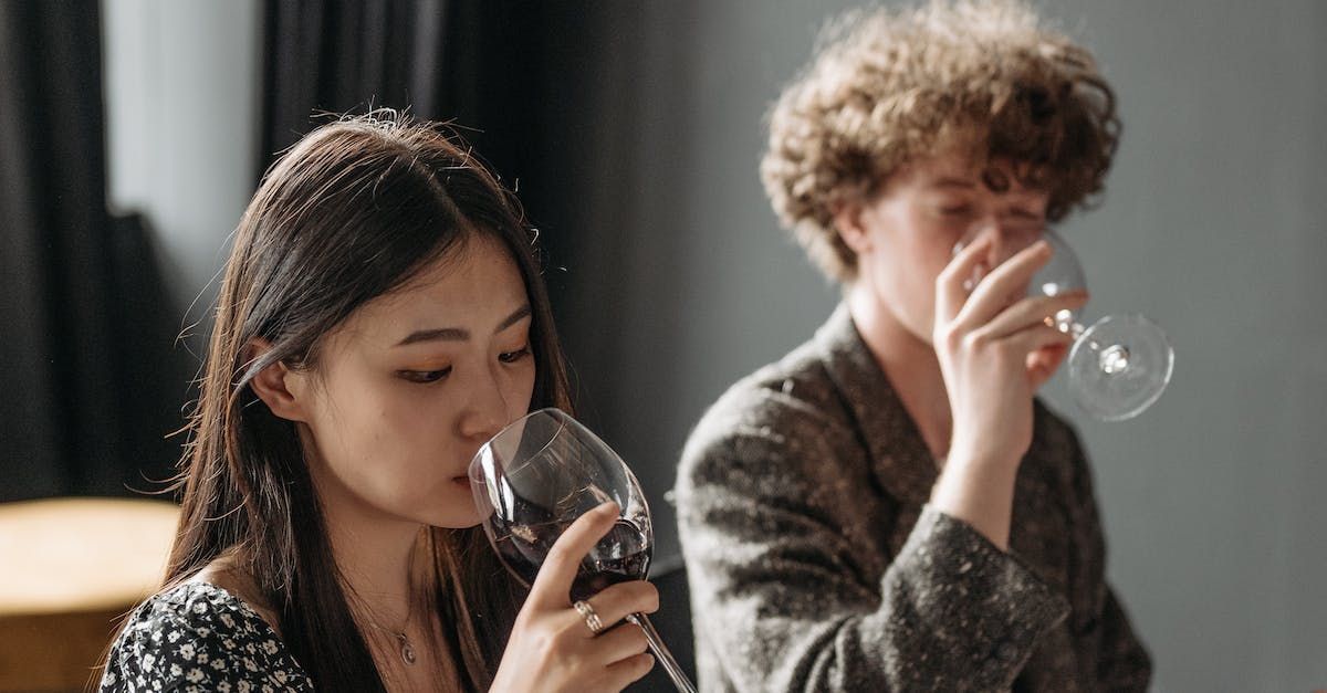 A man and a woman are drinking wine together.