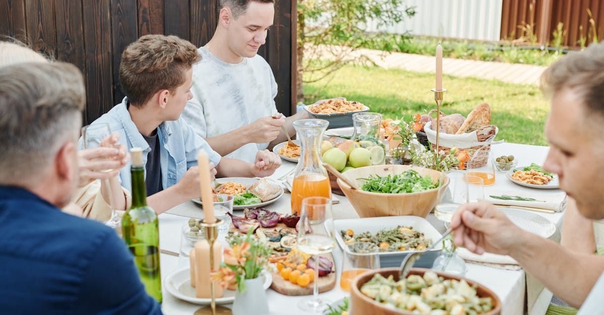 A group of people are sitting at a table eating food.