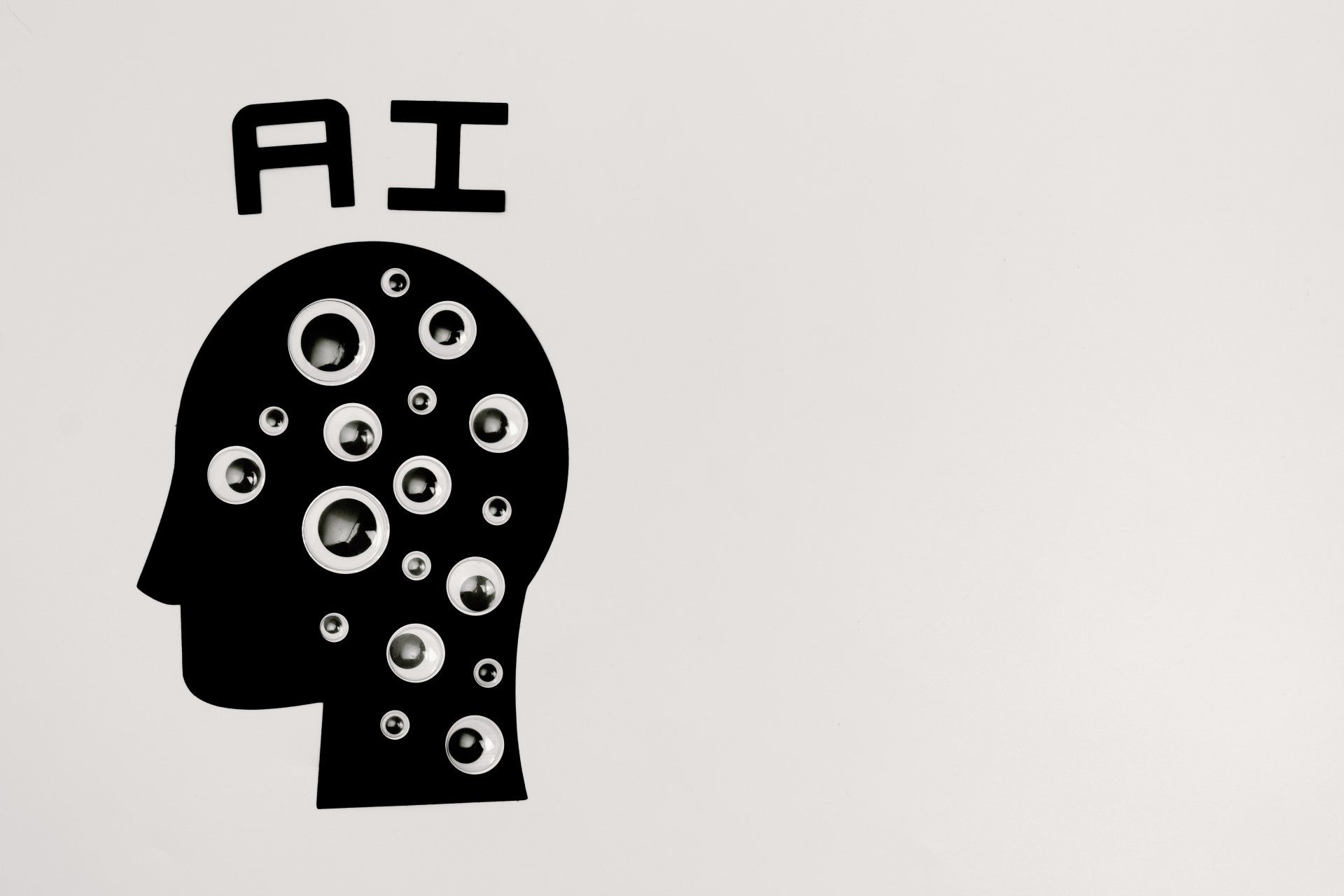 a black and white drawing of a human head with bubbles coming out of it and the letters AI over it.
