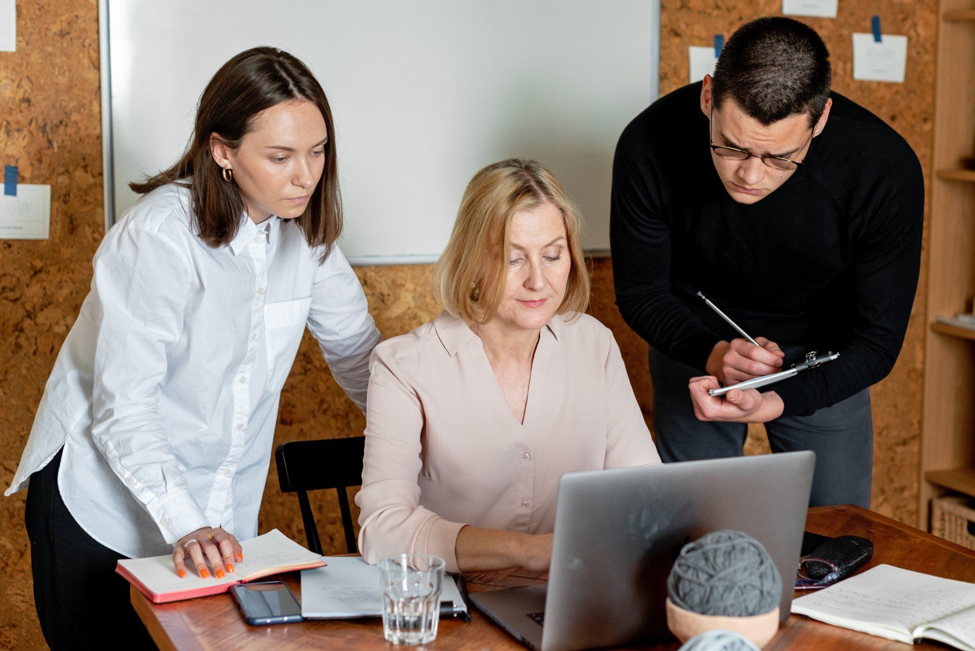 group of people working together at a computer