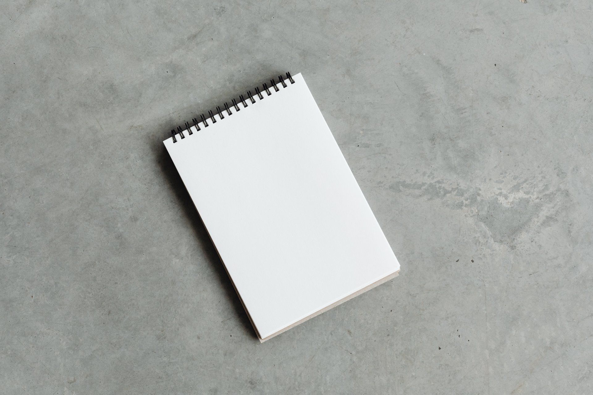 a sketch pad on a concrete flooring