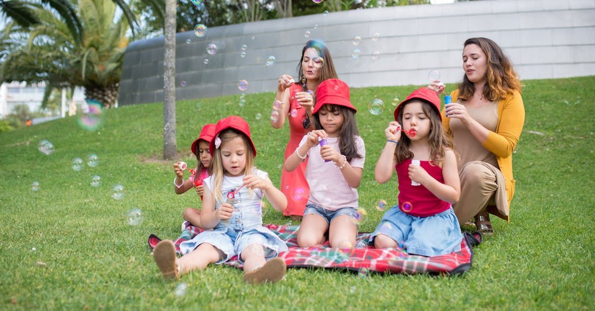 A group of young girls sitting on artificial grass.