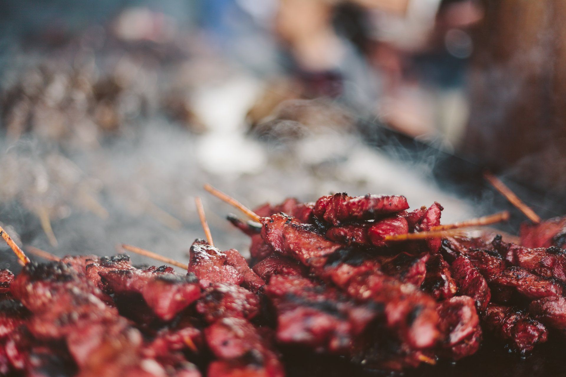 a bunch of meat is being cooked on a grill .