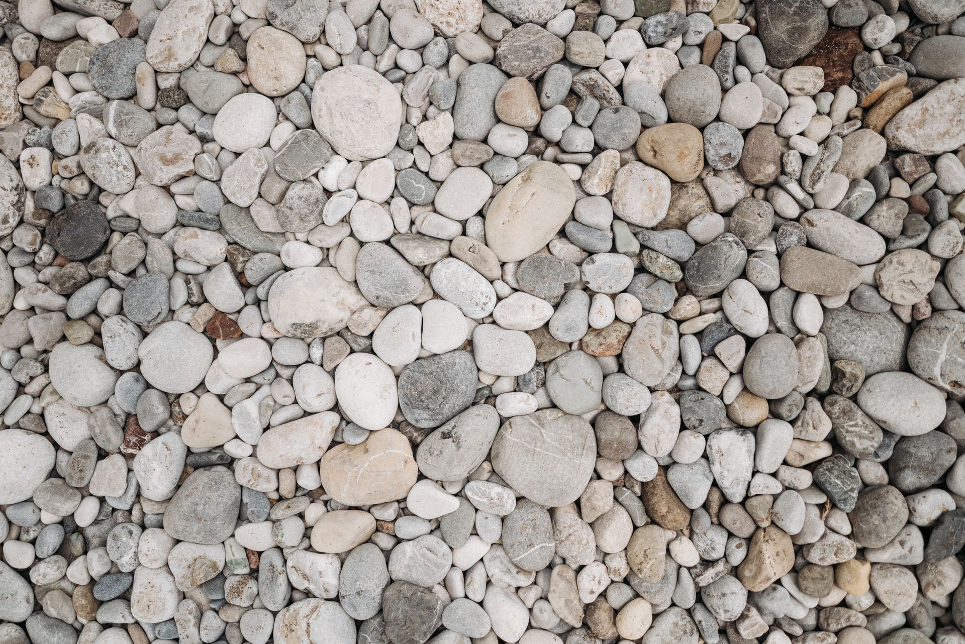 A pile of rocks is sitting on the ground.