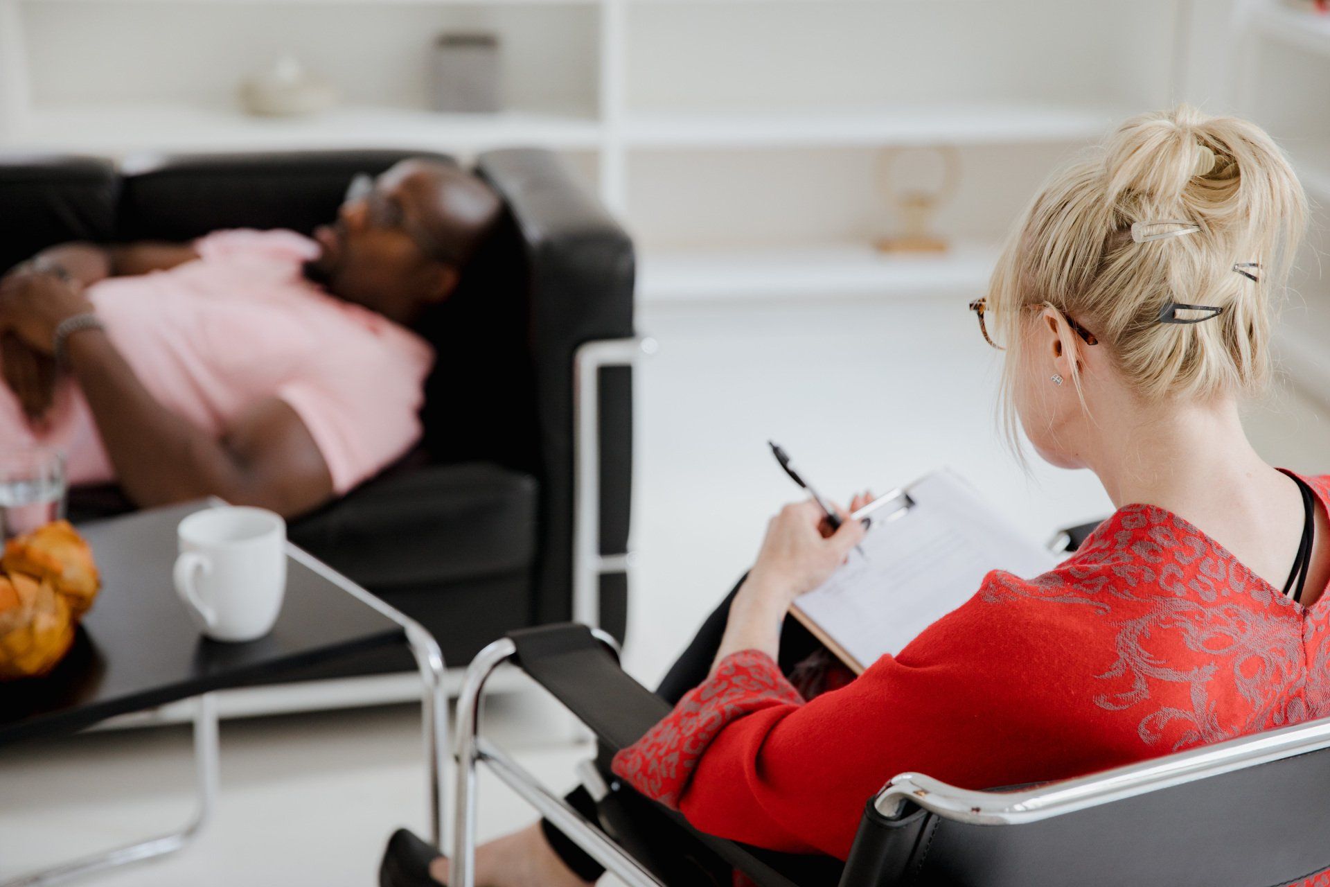 man and woman tms therapy patient sitting on couch