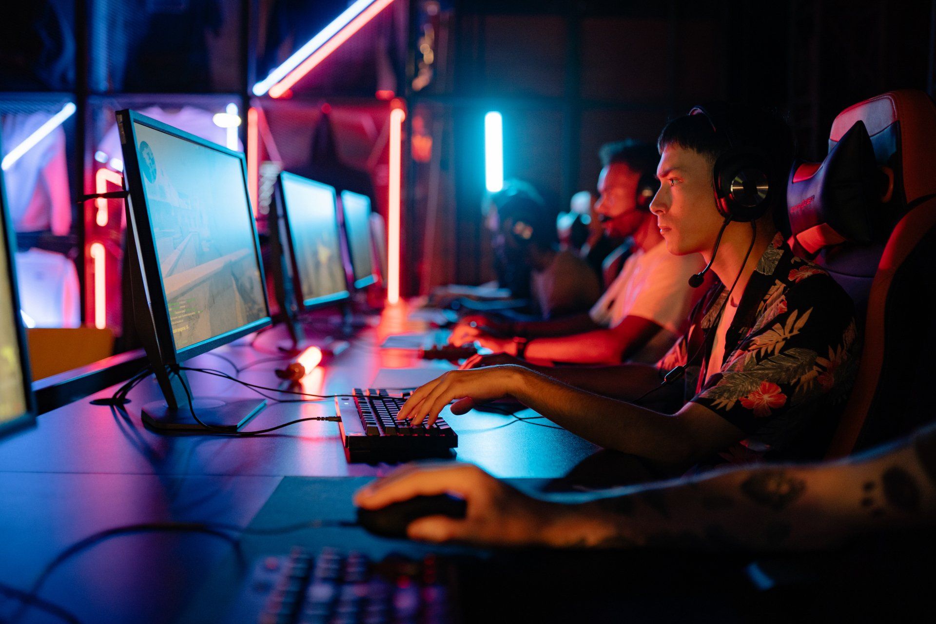 A group of people are sitting at a table playing a video game.