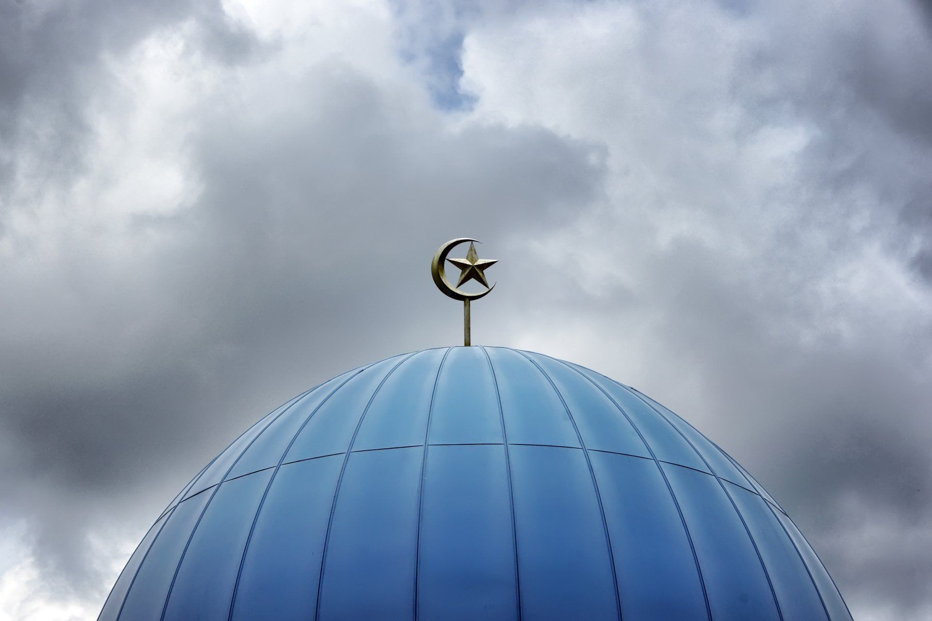 a blue dome with a crescent moon and star on top of it