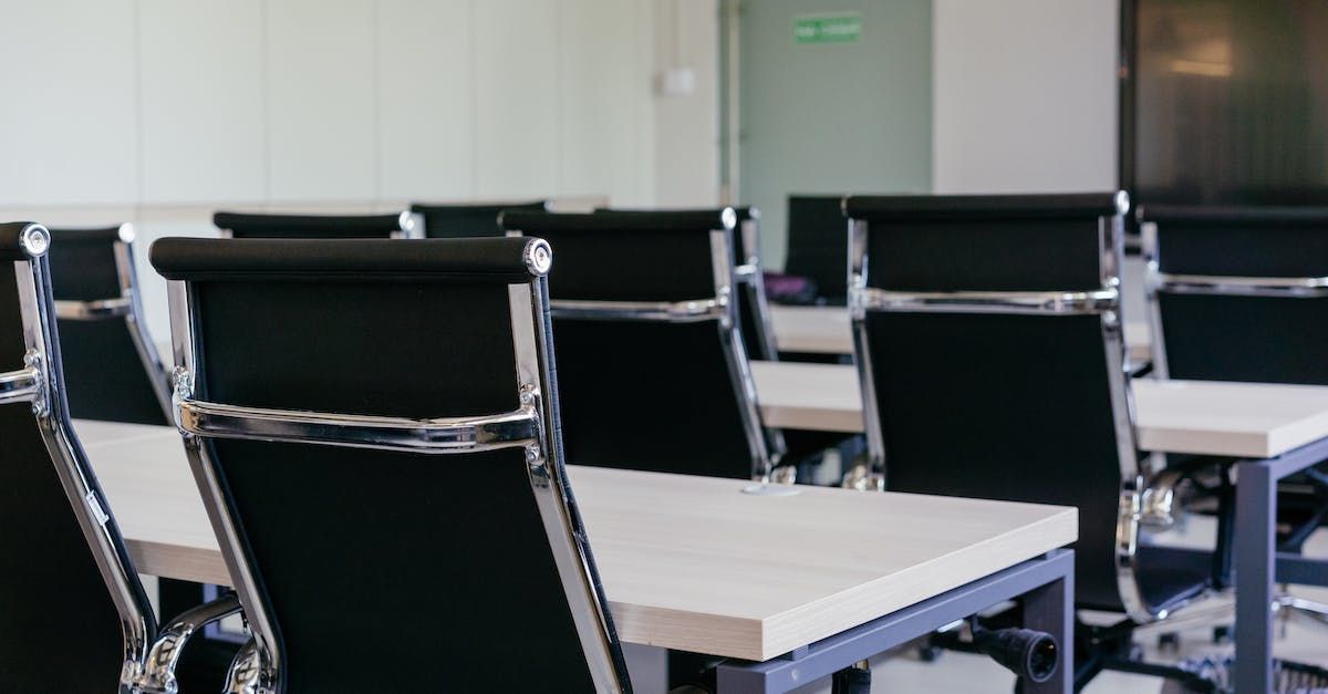Rows of empty chairs in conference room setting