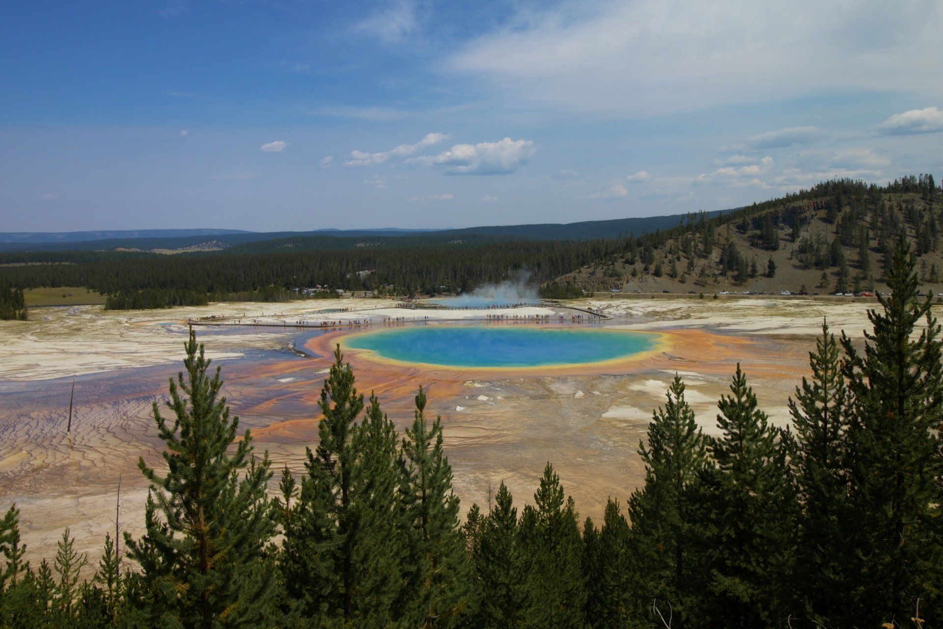 A view of a colorful lake surrounded by trees.