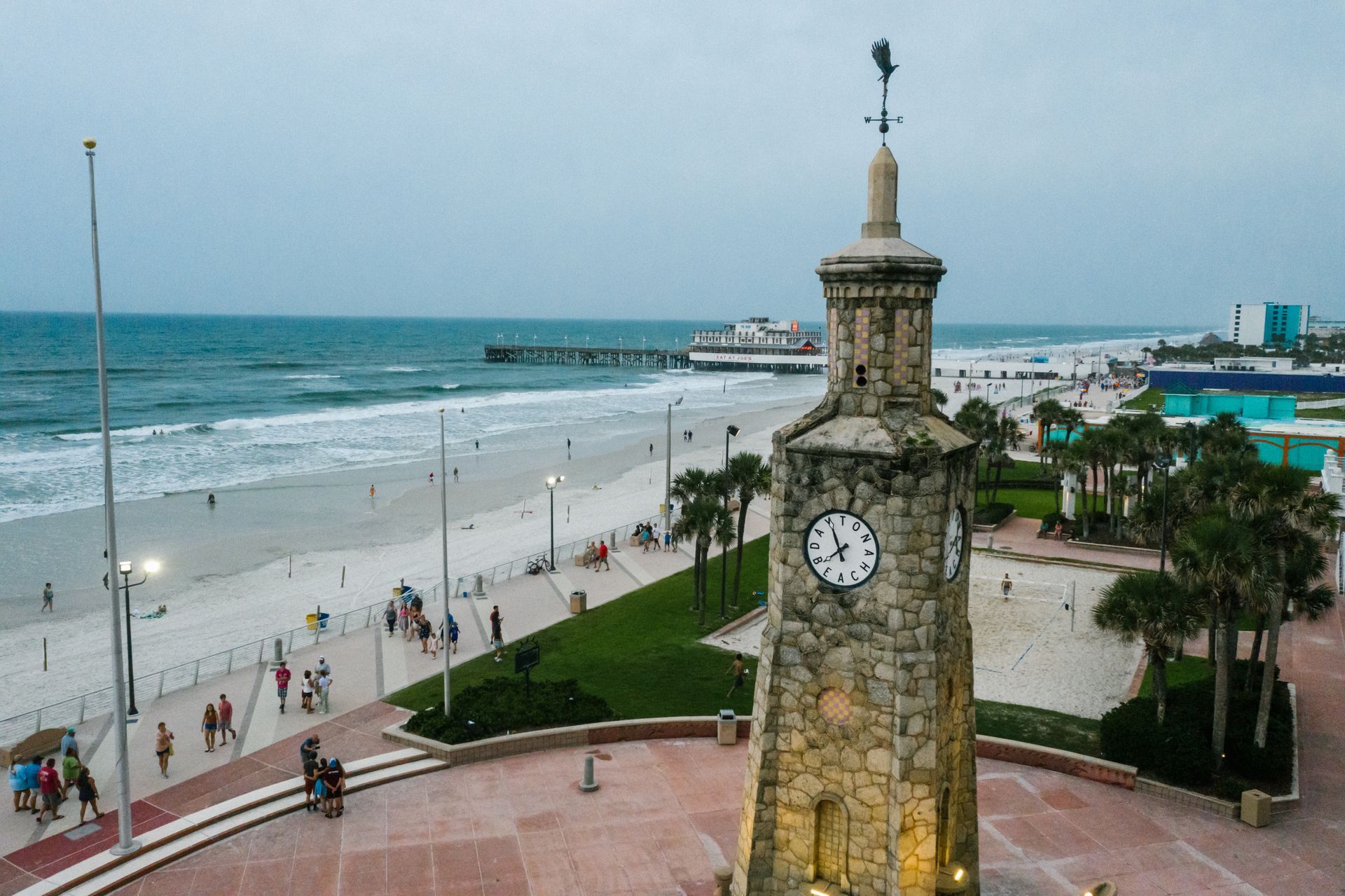 An aerial view of a clock tower on a beach.