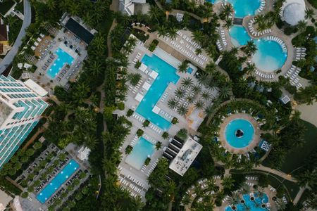 an aerial view of a resort with lots of swimming pools