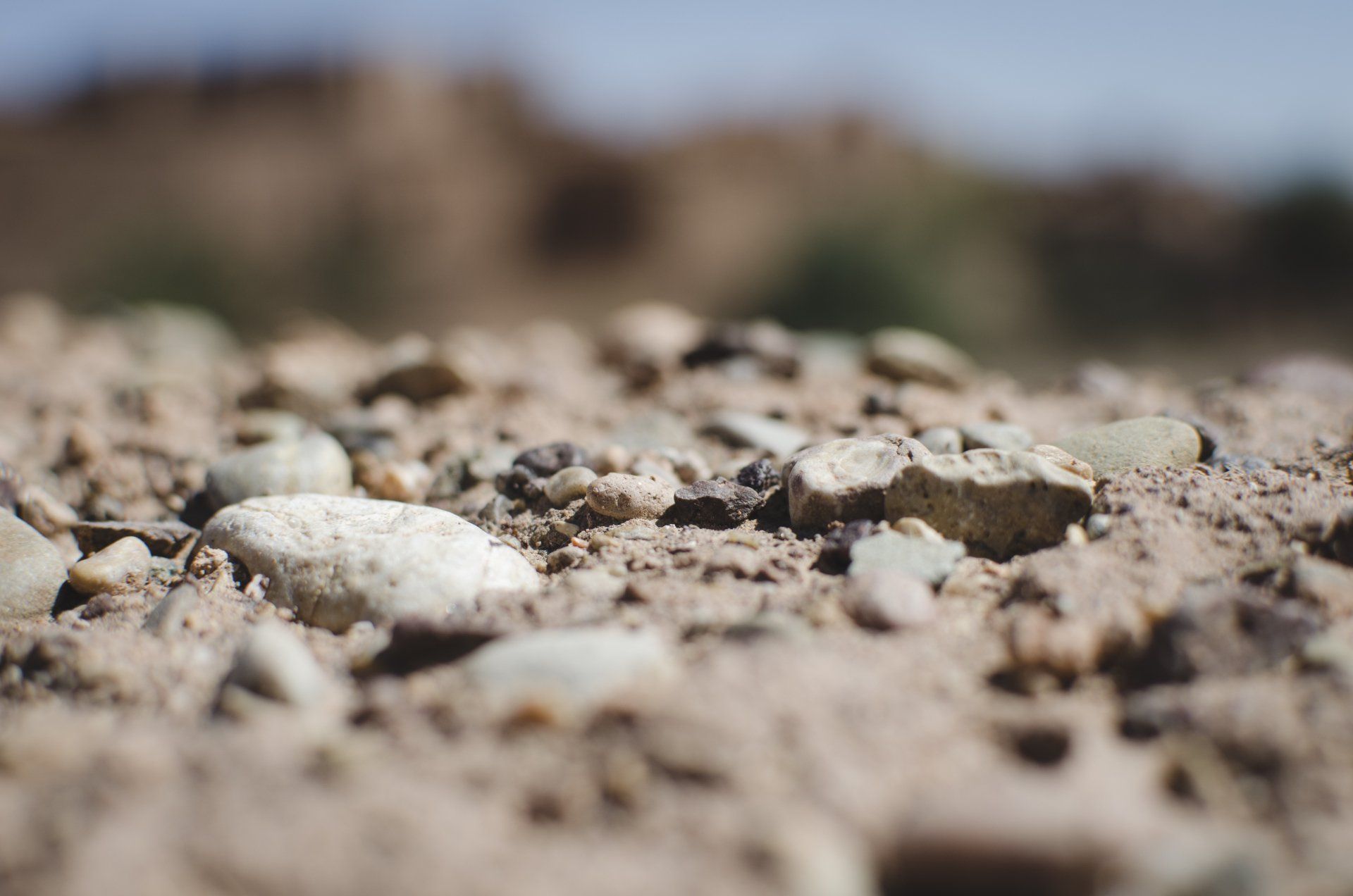 A close up of a pile of rocks and dirt on a dirt road.
