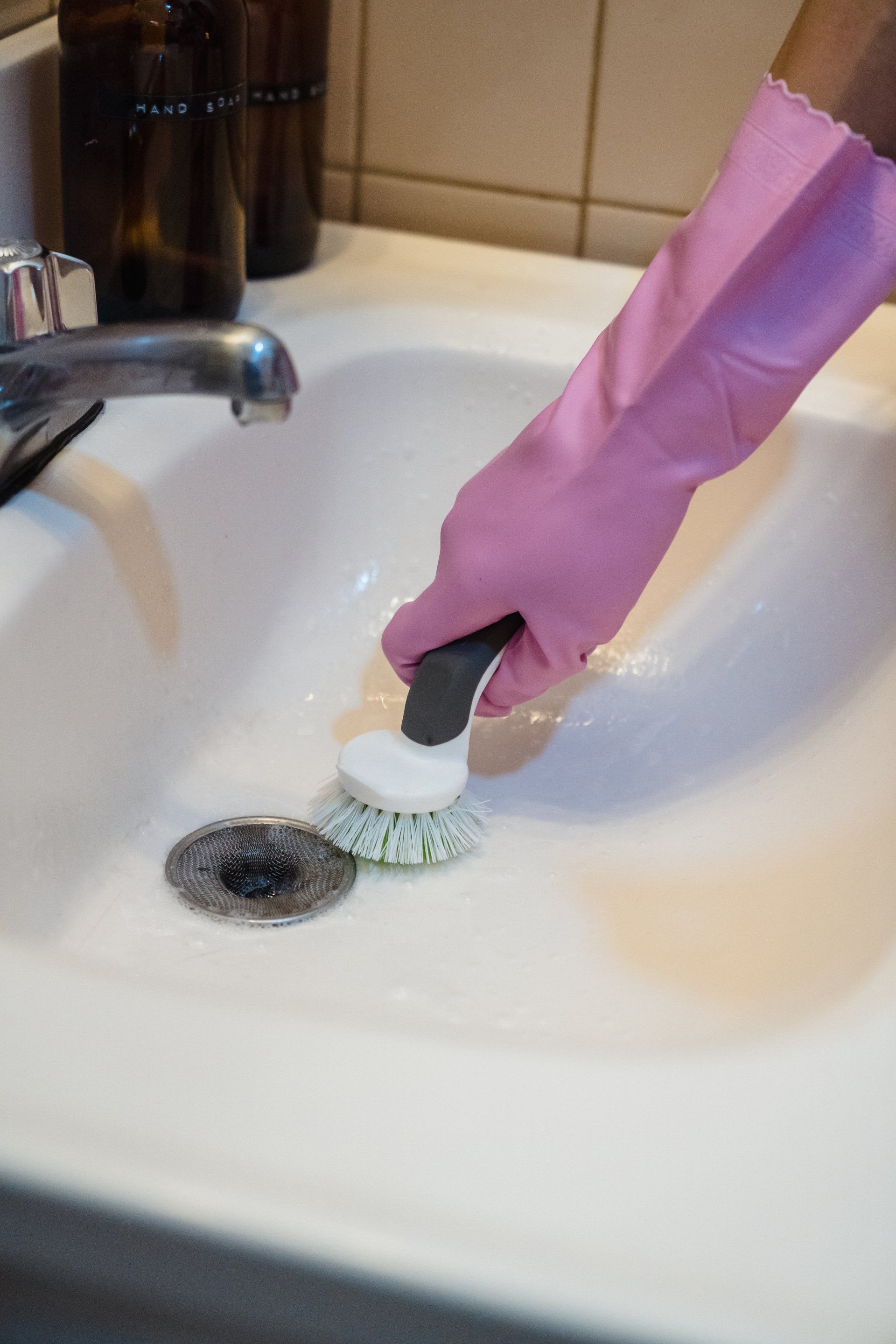 a person cleaning a sink